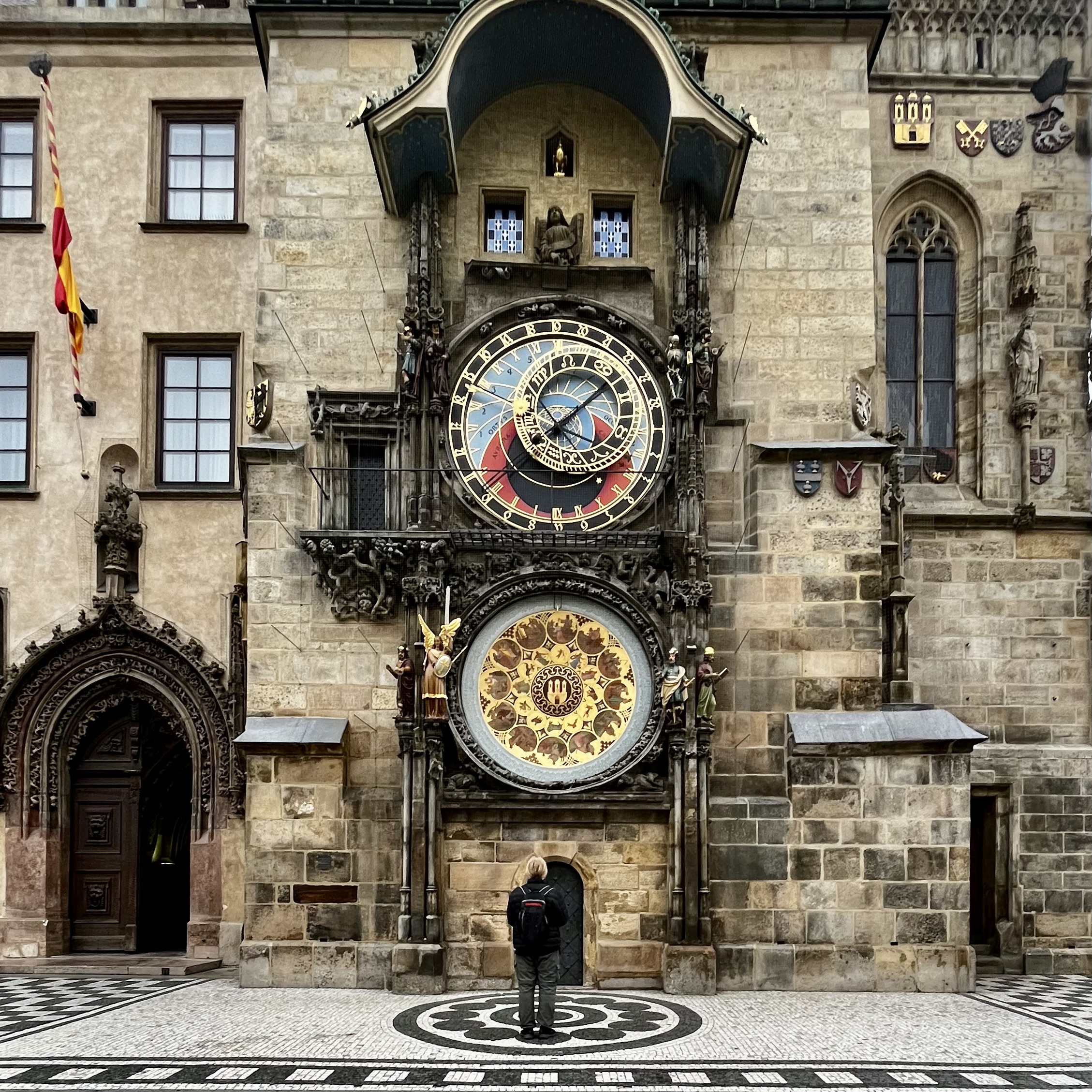 A man looking at the famous Astronomical Clock.